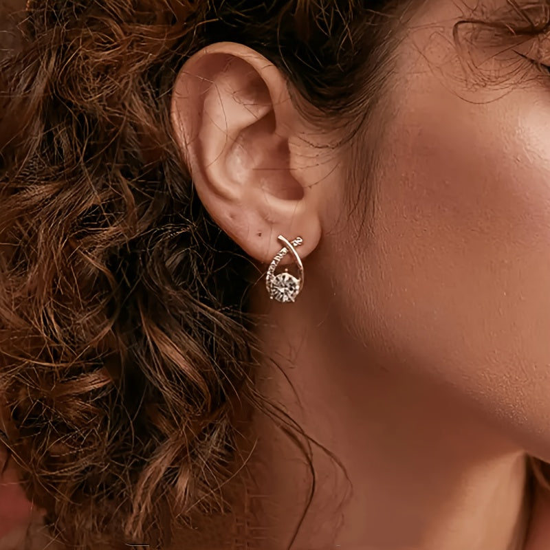Stud earrings with golden cross and zirconia