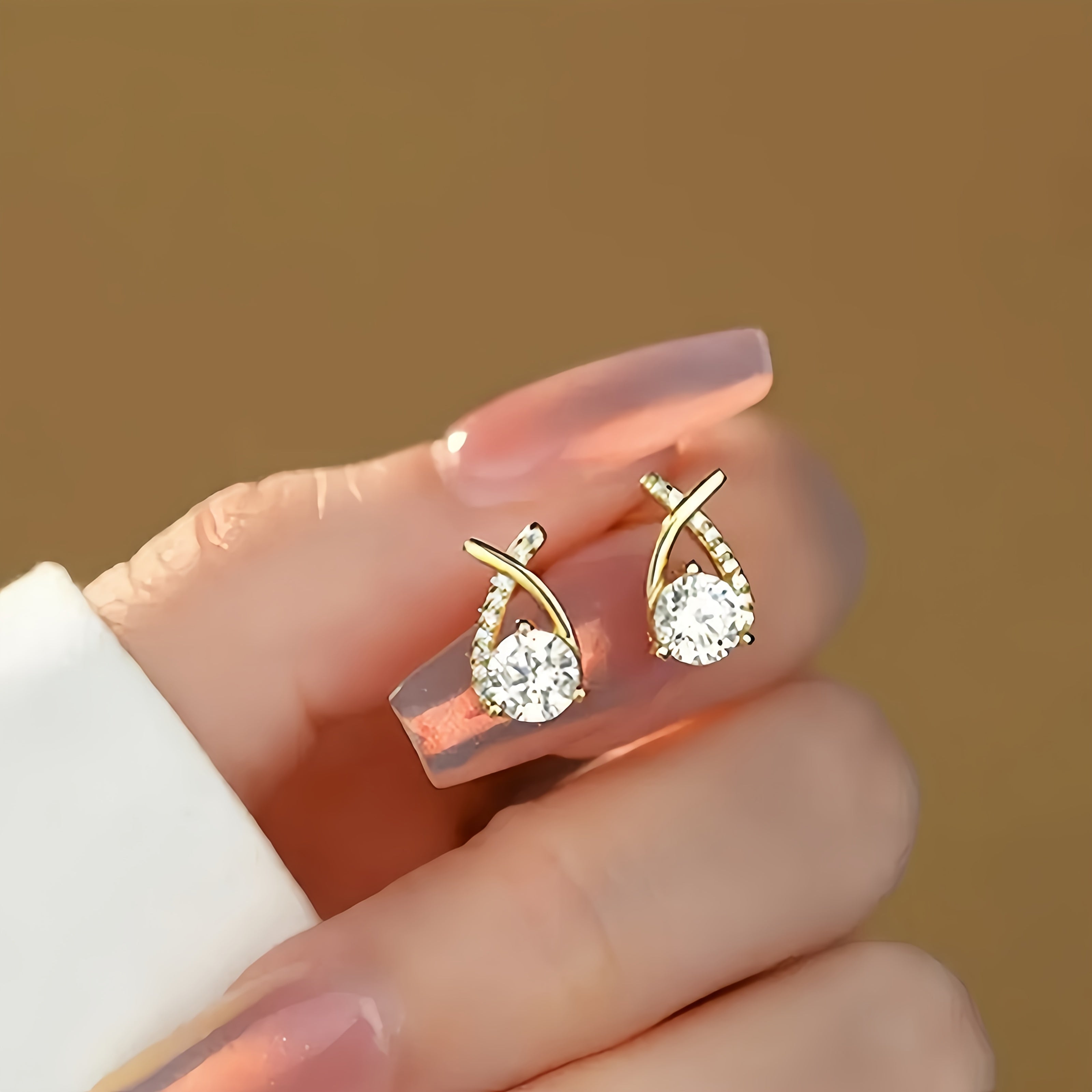 Stud earrings with golden cross and zirconia