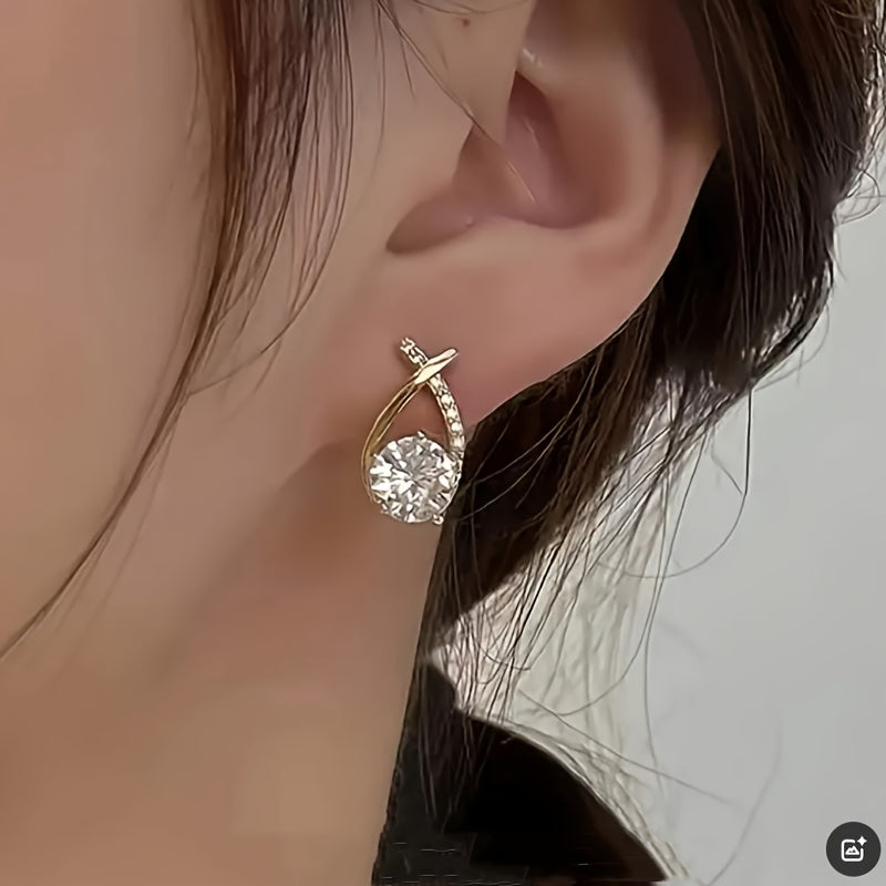 Stud earrings with golden cross and zirconia