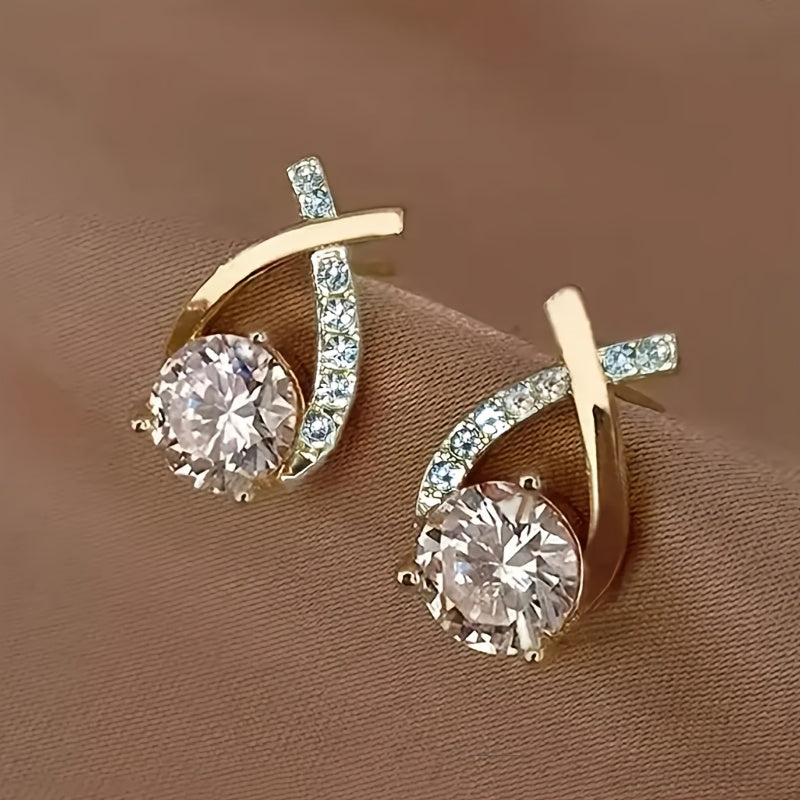 Stud earrings with golden cross and zirconia